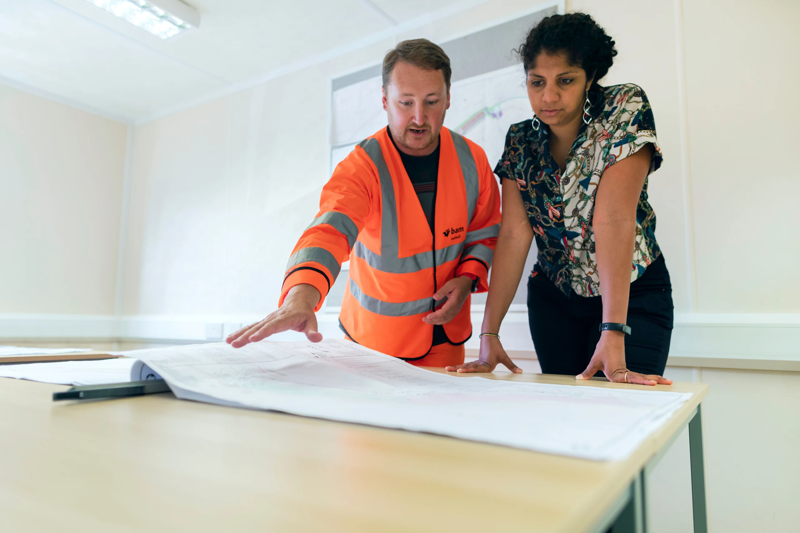 Architect reviewing building drawings at a drafting table