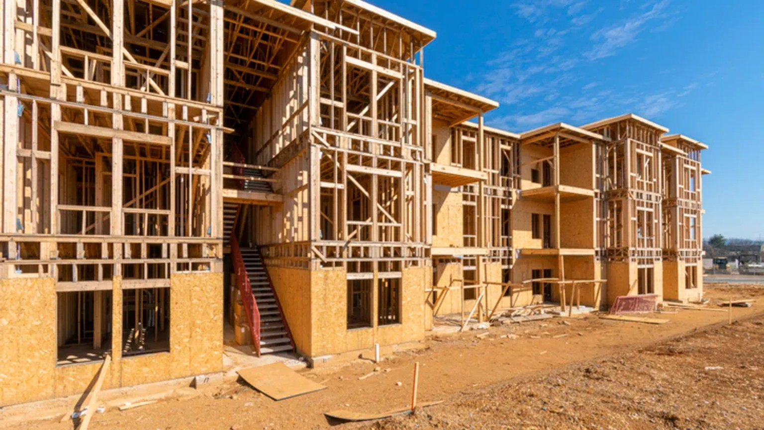 Multifamily apartment complex under construction with wood framing and exterior stairways
