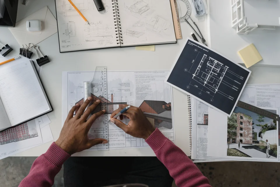 Architect reviewing drawings and plans at a drafting table